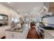 Bright kitchen with white cabinets, stainless steel appliances and island, and hardwood floors, connecting to dining room at 2828 Riverview Blvd, Bradenton, FL 34205