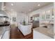 Modern kitchen features white cabinets, stainless steel appliances, and a center island with a stainless steel countertop at 2828 Riverview Blvd, Bradenton, FL 34205