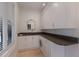 Bright laundry room with sleek cabinets, sink, and modern appliances at 2828 Riverview Blvd, Bradenton, FL 34205