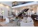 Spacious open-concept living room with a spiral staircase, comfortable seating, and plenty of natural light at 2828 Riverview Blvd, Bradenton, FL 34205