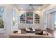 Cozy living room with built-in bookshelves, hardwood floors, comfortable seating, and views of the water at 2828 Riverview Blvd, Bradenton, FL 34205