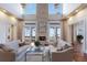 Inviting living room featuring a stone fireplace, hardwood floors, and French doors leading to the backyard at 2828 Riverview Blvd, Bradenton, FL 34205