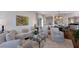 Spacious living room with wood floors, neutral furniture, decor, and open access to the dining and kitchen areas at 2828 Riverview Blvd, Bradenton, FL 34205