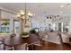 Open-concept living area features wood floors, water views, chandelier, and sliding doors at 2828 Riverview Blvd, Bradenton, FL 34205