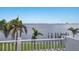 Water view from balcony with palm trees and city skyline in the distance at 2828 Riverview Blvd, Bradenton, FL 34205