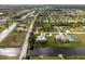 A captivating aerial view of a waterfront home highlighting its lush surroundings and canal access at 292 Long Meadow Ln, Rotonda West, FL 33947