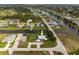 Lovely aerial view of a home with a well-manicured lawn and close proximity to a tranquil canal at 292 Long Meadow Ln, Rotonda West, FL 33947