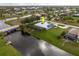 Aerial view of a home with a metal roof, located on a waterfront canal with boat dock at 292 Long Meadow Ln, Rotonda West, FL 33947