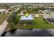 Aerial view of a waterfront home on a canal featuring a metal roof and solar panels at 292 Long Meadow Ln, Rotonda West, FL 33947