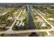 Beautiful aerial view of a canal front home with mature landscaping and a serene waterfront setting at 292 Long Meadow Ln, Rotonda West, FL 33947