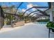 Backyard oasis with a screened pool, hot tub, and tropical landscaping at 292 Long Meadow Ln, Rotonda West, FL 33947