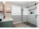 Modern bathroom featuring a sleek shower with glass door, stone floor and gray accents at 292 Long Meadow Ln, Rotonda West, FL 33947
