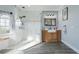 Updated bathroom featuring a glass shower, wood style vanity, and tiled floors, complemented by soft natural light at 292 Long Meadow Ln, Rotonda West, FL 33947