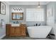 Bathroom features a rustic style vanity with a free standing soaking tub and modern finishes at 292 Long Meadow Ln, Rotonda West, FL 33947