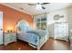 Comfortable bedroom with wood floors, neutral walls, large windows with outside views and ample dresser storage at 292 Long Meadow Ln, Rotonda West, FL 33947