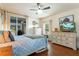 Spacious bedroom featuring a ceiling fan, wood floors, and a slider to the outdoor patio at 292 Long Meadow Ln, Rotonda West, FL 33947