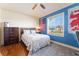 Well lit bedroom with comfortable bed, wood floors, patriotic decorations, and view of the outdoors at 292 Long Meadow Ln, Rotonda West, FL 33947