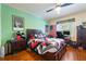 Cozy bedroom features hardwood floors, natural light, and modern decor; perfect for relaxing or sleep at 292 Long Meadow Ln, Rotonda West, FL 33947