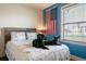 Relaxing bedroom with natural light, wood accent headboard, a comfortable bed, and a patriotic theme at 292 Long Meadow Ln, Rotonda West, FL 33947