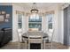 Bright dining area with large windows, charming decor, and easy access to the kitchen and living spaces at 292 Long Meadow Ln, Rotonda West, FL 33947