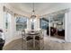 Cozy dining area with large windows overlooking the outdoor living space, perfect for enjoying meals with a view at 292 Long Meadow Ln, Rotonda West, FL 33947
