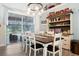 Inviting dining room features a wooden table and chairs, stylish light fixture, and sliding door access to the pool area at 292 Long Meadow Ln, Rotonda West, FL 33947