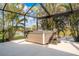 Outdoor hot tub on screened lanai overlooking a lake, surrounded by lush tropical foliage at 292 Long Meadow Ln, Rotonda West, FL 33947
