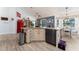 Open concept kitchen featuring granite countertops, modern appliances, and an island with seating and custom cabinets at 292 Long Meadow Ln, Rotonda West, FL 33947
