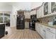 Modern kitchen features stainless steel appliances, granite countertops, and stylish cabinetry with ample storage space at 292 Long Meadow Ln, Rotonda West, FL 33947