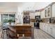 Spacious kitchen with granite countertops, custom cabinetry, and a unique island with a rustic wood design at 292 Long Meadow Ln, Rotonda West, FL 33947