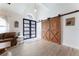 Charming living room featuring a modern barn door, sleek flooring, and inviting ambiance at 292 Long Meadow Ln, Rotonda West, FL 33947