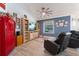 Relaxing living room with a vintage Coca-Cola fridge, comfortable seating, and natural light from the large window at 292 Long Meadow Ln, Rotonda West, FL 33947