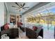 Inviting screened patio with comfortable seating, ceiling fan, and access to a sparkling pool at 292 Long Meadow Ln, Rotonda West, FL 33947