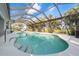 Lush backyard featuring a sparkling pool within a screened enclosure surrounded by greenery at 292 Long Meadow Ln, Rotonda West, FL 33947