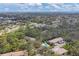 An aerial view shows a neighborhood with mature trees, condos, and a community pool at 3330 Thornwood Rd # 3330, Sarasota, FL 34231