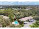 Aerial view of the community featuring the pool, creek, bridge and lush trees at 3330 Thornwood Rd # 3330, Sarasota, FL 34231