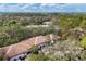 An aerial perspective shows condos nestled among mature trees, featuring a pool and parking areas at 3330 Thornwood Rd # 3330, Sarasota, FL 34231