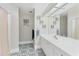 Bathroom with white vanity, decorative mirror, and patterned tile flooring at 3330 Thornwood Rd # 3330, Sarasota, FL 34231