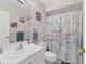 Bathroom featuring patterned shower curtain and an oversized mirror at 3330 Thornwood Rd # 3330, Sarasota, FL 34231