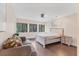 Bright bedroom features hardwood floors, a comfy couch and a king bed at 3330 Thornwood Rd # 3330, Sarasota, FL 34231