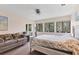 Bedroom featuring three windows with a loveseat and bed with side table at 3330 Thornwood Rd # 3330, Sarasota, FL 34231
