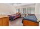 Bedroom with hardwood floors, two twin-sized beds, and an overhead ceiling fan at 3330 Thornwood Rd # 3330, Sarasota, FL 34231