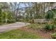 Entrance to Crooked Creek with decorative sign and established trees and landscaping at 3330 Thornwood Rd # 3330, Sarasota, FL 34231