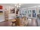 Stylish dining area with a glass-top table, modern lighting, and view of the outdoor area at 3330 Thornwood Rd # 3330, Sarasota, FL 34231