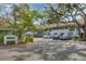 Condominium exterior showing mature trees, neutral paint and assigned parking at 3330 Thornwood Rd # 3330, Sarasota, FL 34231