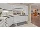 Contemporary kitchen featuring white cabinetry, stainless steel appliances, and a view into the dining room at 3330 Thornwood Rd # 3330, Sarasota, FL 34231