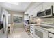 Bright kitchen with white cabinets, modern appliances, and a view of the outdoors from the window at 3330 Thornwood Rd # 3330, Sarasota, FL 34231
