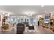 Open concept living room with modern lighting and plenty of windows bringing in natural light at 3330 Thornwood Rd # 3330, Sarasota, FL 34231