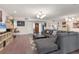 Spacious living room features modern lighting, tile floors, and a cozy gray sectional sofa at 3330 Thornwood Rd # 3330, Sarasota, FL 34231