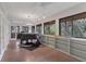 Hardwood floor living room featuring recessed lighting and a grand piano with forest views at 3330 Thornwood Rd # 3330, Sarasota, FL 34231